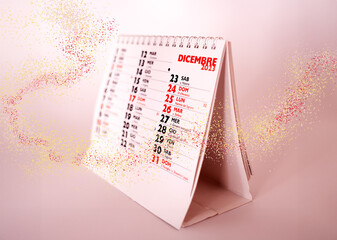 December calendar with Christmas holiday highlighted, pale pink background, bright trail of...