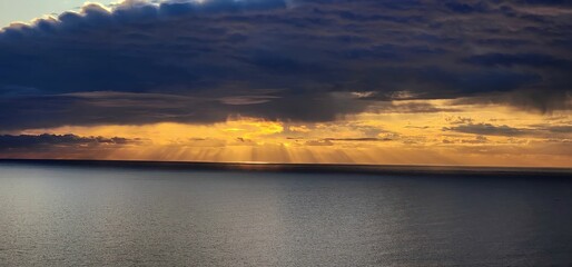 Sunlight breaking through stormy clouds in Hout Bay, South Africa 