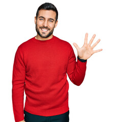 Young hispanic man wearing casual clothes showing and pointing up with fingers number five while smiling confident and happy.