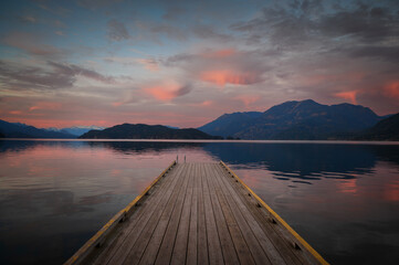 Sunset with Long Pier Leading Out into Water.  Harrison Lake, BC, Canada area is breathtaking with...
