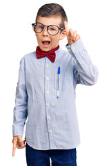 Cute blond kid wearing nerd bow tie and glasses pointing finger up with successful idea. exited and...