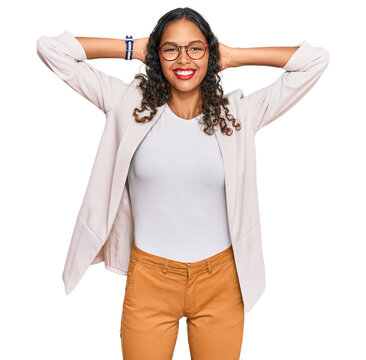 Young african american girl wearing business clothes relaxing and stretching, arms and hands behind head and neck smiling happy