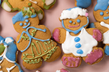 Christmas gingerbread in the shape of men decorated with colorful icing, top view