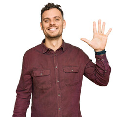 Young hispanic man wearing casual clothes showing and pointing up with fingers number five while smiling confident and happy.