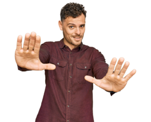 Young hispanic man wearing casual clothes doing stop gesture with hands palms, angry and frustration expression