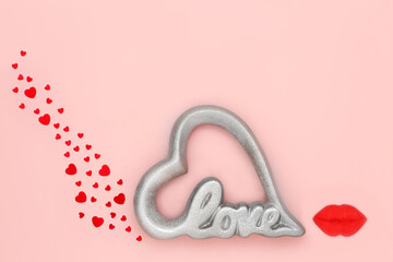 Valentine love heart sign with luscious lips and red confetti hearts on pink background. Abstract...