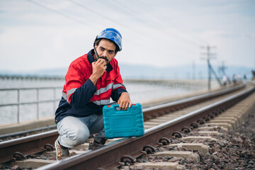 Service Engineer inspecting and maintenance railroad tracks. Industrial Worker checking and working...