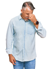 Middle age grey-haired man wearing casual clothes tired rubbing nose and eyes feeling fatigue and headache. stress and frustration concept.