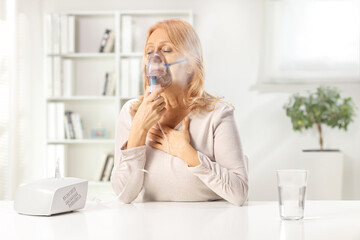 Woman using a nebulizer with vapor mist