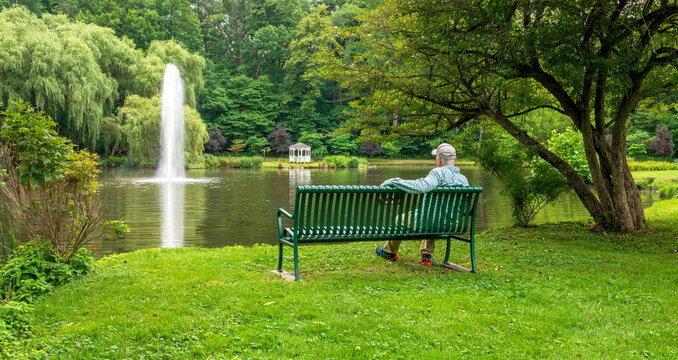 Senior citizen on bench enjoying peace and tranquility in public park