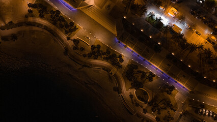 Aerial night background of Civitavecchia panorama. port edge with Fort Michelangelo and golden sand.