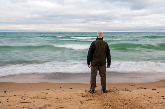 Senior citizen hiker on shore of Lake Michigan of the Great Lakes 