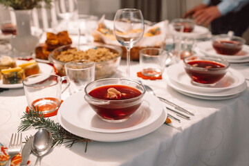 Red borscht with ravioli stuffed with sauerkraut and mushrooms and other traditional Polish Christmas Eve dishes - obrazy, fototapety, plakaty