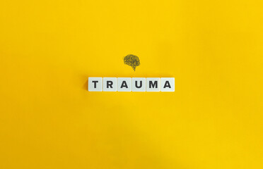 Trauma and Brain. Block Letter Tiles on Yellow Background. Minimal Aesthetics.