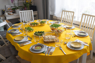 Easter family celebration. Traditional Polish dishes on a wooden table with yellow tablecloth. High quality photo