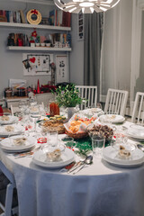 Polish Wigilia. Christmas Eve red borscht soup with mushroom filled ravioli and beet chips and sauerkraut with mushrooms on festive table. High quality photo