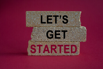 Let's get started symbol. Motivational quote Let us get started on brick blocks. Beautiful red...