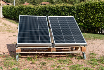 Photovoltaic panels on the wooden pallet in the home garden. Green energy concept.