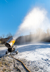 Snow cannon is producing artificial snow for ski slopes in Cunardo sky resort, province of Varese, Lombardy, Italy
