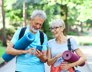 woman man senior couple active fitness elderly phone mobile smartphone happy together communication active outdoor healthy vitality exercise mat class training