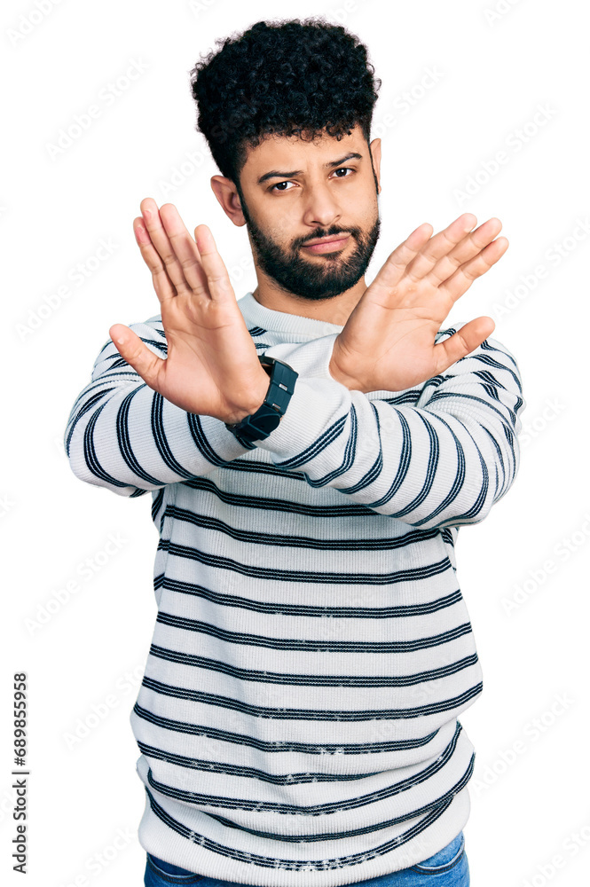 Canvas Prints Young arab man with beard wearing casual striped sweater rejection expression crossing arms doing negative sign, angry face