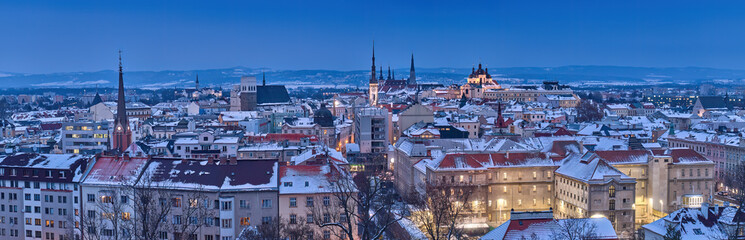 Panoramic,  winter  view of illuminated towers and churches of city Olomouc in blue hour, UNESCO site, ancient town and tourist spot in Central Moravia, Czech Republic.
