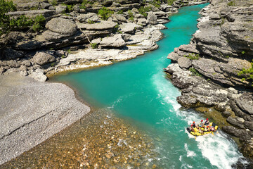 White water rafting.  Adventure and sport. A yellow raft floating among the rocks on the crystal...