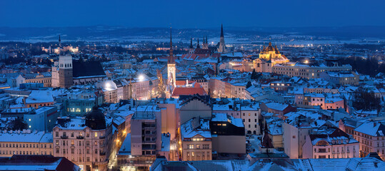 Panoramic,  winter  view of illuminated towers and churches of city Olomouc in blue hour, UNESCO site, ancient town and tourist spot in Central Moravia, Czech Republic.