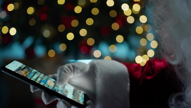 Nostalgic Santa Claus looking for memories on his Phone 