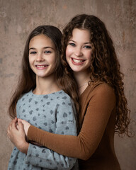 Portrait of two beautiful smiling sisters
