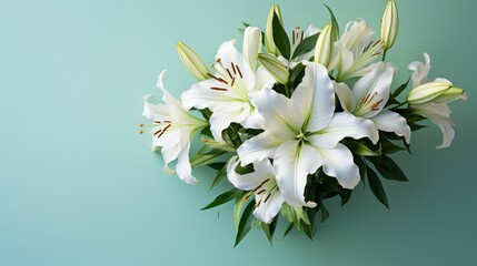 A top-down view of a bouquet of white lilies set against a mint-green backdrop, capturing the...
