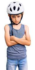 Little cute boy kid wearing bike helmet skeptic and nervous, disapproving expression on face with crossed arms. negative person.