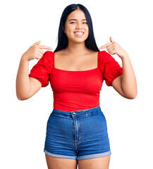 Obraz premium Young beautiful asian girl wearing casual clothes looking confident with smile on face, pointing oneself with fingers proud and happy.