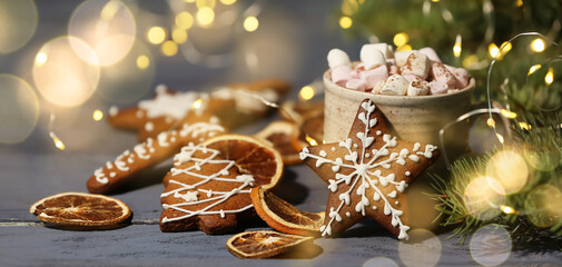 Cup of hot chocolate, gingerbread cookies, fir branch and dry orange slices on table