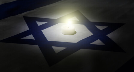 Burning candle on flag of Israel. International Holocaust Remembrance Day