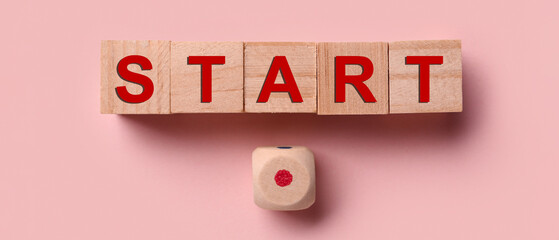 Cubes with word START on pink background