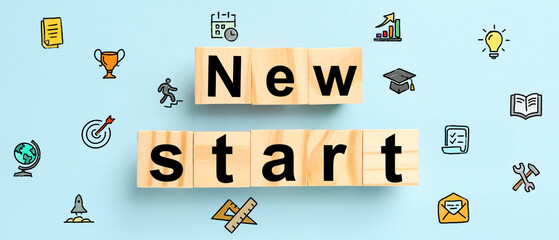 Wooden cubes with text NEW START on light blue background