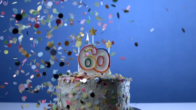 Celebrating 60 year old age symbolized in birthday cake with confetti falling in slow-motion with candle, anniversary milestone celebration