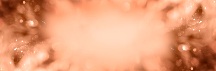 Blurred background of peach fuzz Christmas tinsel. Web-banner