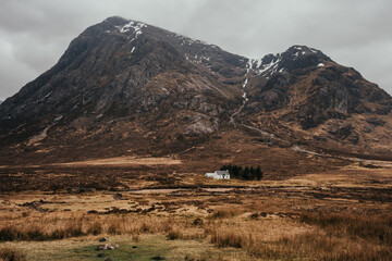 Beautiful vista with the white house and waterfalls near Three Sisters Mountains in Glencoe, the Scottish Highlands, Scotland UK - obrazy, fototapety, plakaty