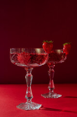 Two glasses of rose sparkling wine on red background romantic valentine's day concept