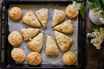 scones with cherries on a wooden background.