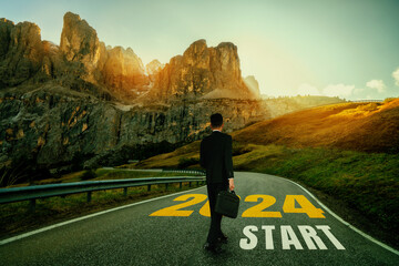 2024 New Year journey and future vision concept . Businessman traveling on highway road leading...