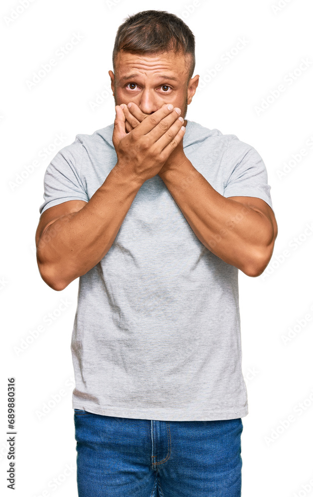 Canvas Prints Handsome muscle man wearing casual grey tshirt shocked covering mouth with hands for mistake. secret concept.