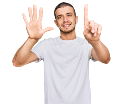 Hispanic young man wearing casual white t shirt showing and pointing up with fingers number six while smiling confident and happy.