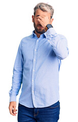 Young handsome blond man wearing elegant shirt tired rubbing nose and eyes feeling fatigue and headache. stress and frustration concept.