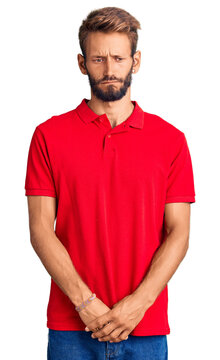 Handsome blond man with beard wearing casual clothes depressed and worry for distress, crying angry and afraid. sad expression.