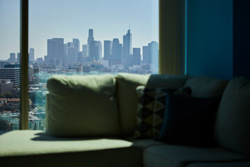 View of downtown Los Angeles from my apartment. With the sofa and cushions in the foreground out of focus.
