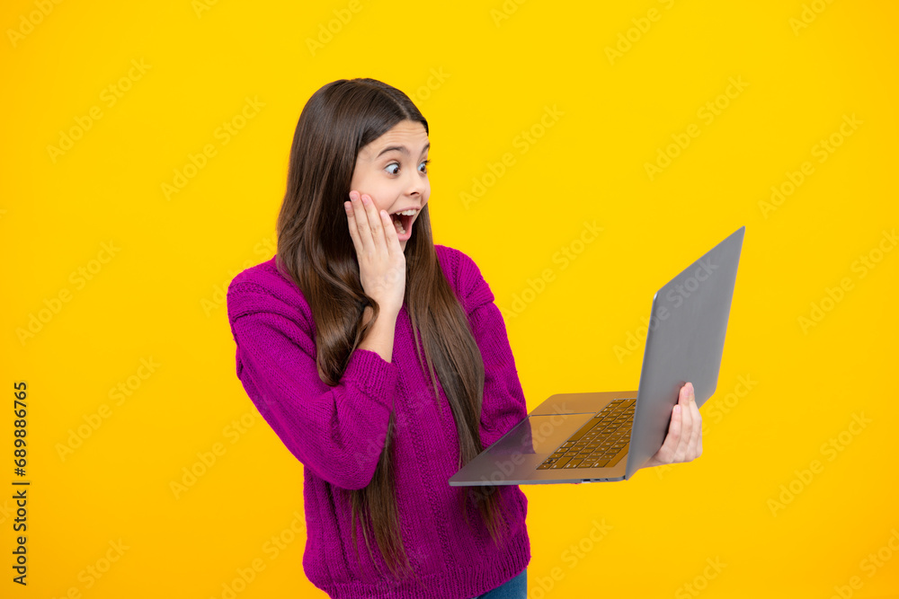 Canvas Prints excited face. smart little boy with laptop in casual clothes isolated over yellow background. amazed