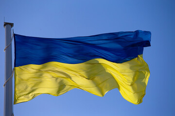 National flag of Ukraine against blue sky